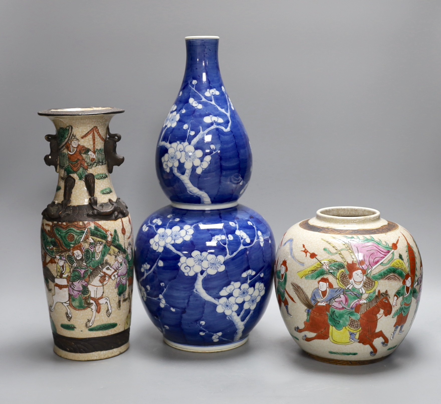 A Chinese crackle glaze vase and jar and a blue with figural decoration, together with a Chinese blue and white prunus double gourd vase, tallest 37cm